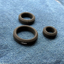 Pure soft silicone cock rings resting on jeans, battery-free